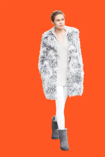 A girl wear Grey Fur Coat With White Skinny Jeans